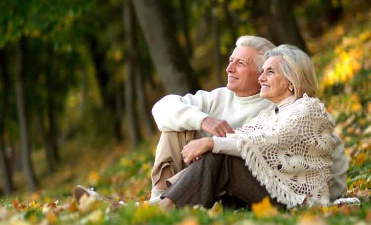 elderly couple enjoying sitting in the park